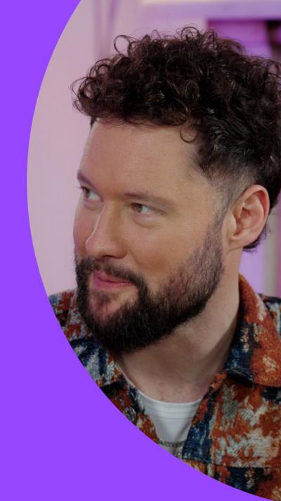 Calum Scott looking to the left and smiling
