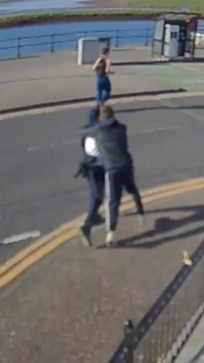 Teenagers running in the street.