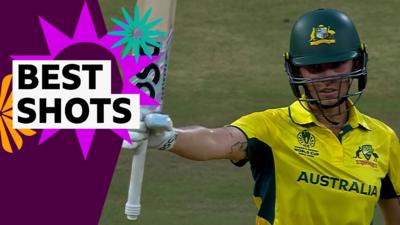 Ash Garnder raises her bat to celebrate reaching her century
