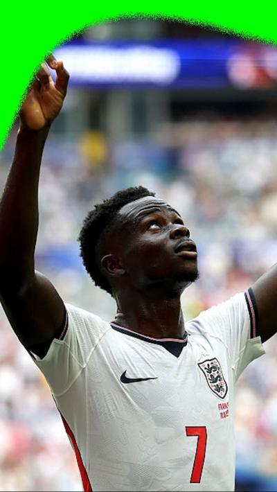 Bukayo Saka points to the sky to celebrate a third goal for England against France in the 2026 World Cup.