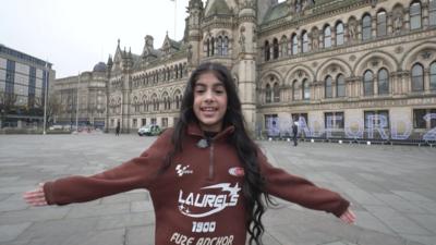 Shifa standing outside Bradford City Hall. 