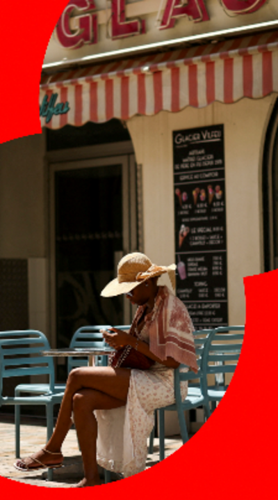 A woman sat outside a closed ice cream parlour