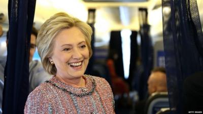 Hillary Clinton speaks to reporters on her campaign plane