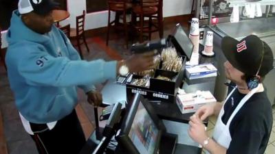 A cashier at Jimmy John's takeaway in Kansas City, Missouri tells the BBC how he kept his astonishing cool when a robber stuck a gun in his face.