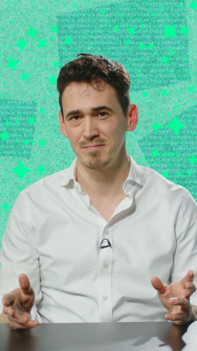 Man wearing white shirt looks at the camera