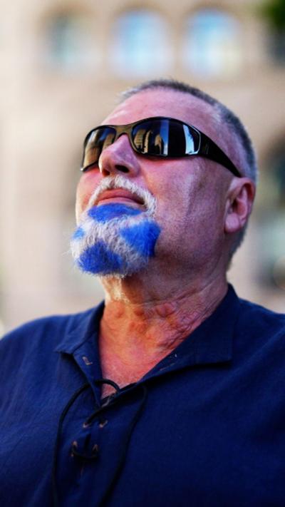 A male Scotland fan with a saltire in his beard