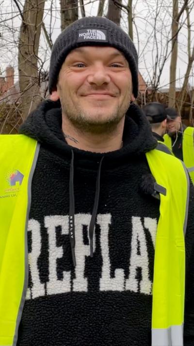 Man dressed in high viz clothing on a litter picking trip