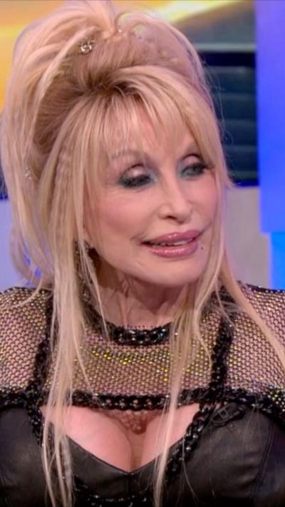 Dolly looks to her right as she sits on the One Show sofa