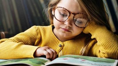 A child reads a picture book