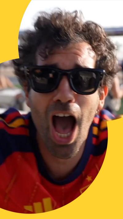 Man with short dark curly hair, wearing sunglasses. He's shouting at the camera.