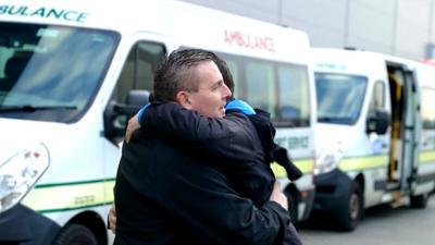 Volunteers hugging at the Ukrainian frontline