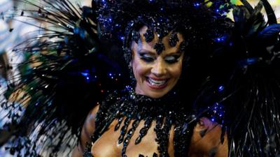 A woman poses in carnival costume in Sao Paolo