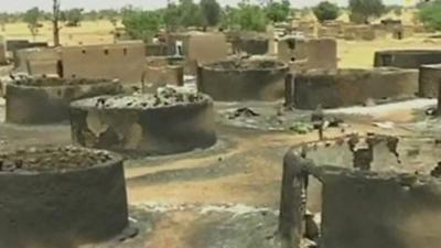 Burned out huts in a village