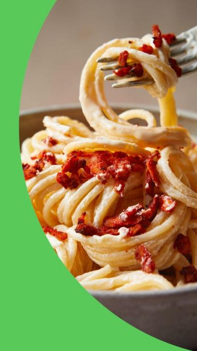 Image of pasta in a grey bowl with a fork lifting some out