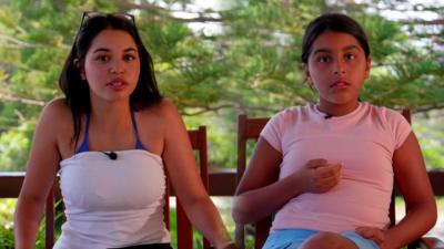 Two Tunisian children sit down on chairs and talk to the camera
