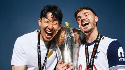 tSon Heung-min and James Maddison of Tottenham Hotspur pose for a photo with the Uefa Europa League trophy