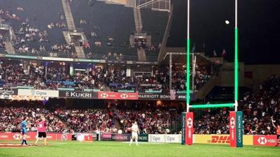 Rugby posts lit green at match