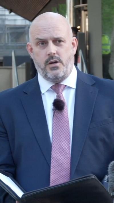 Laurence Taylor in a suit and pink tie