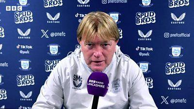 Preston North End assistant manager Stuart McCall talks into a purple BBC Radio Lancashire microphone