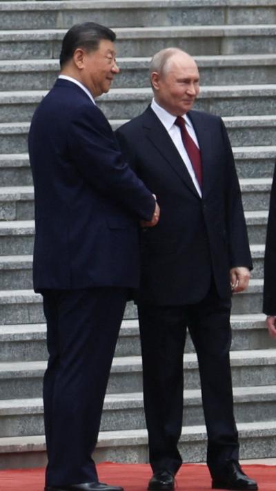 Russian President Vladimir Putin is welcomed by Chinese President Xi Jinping