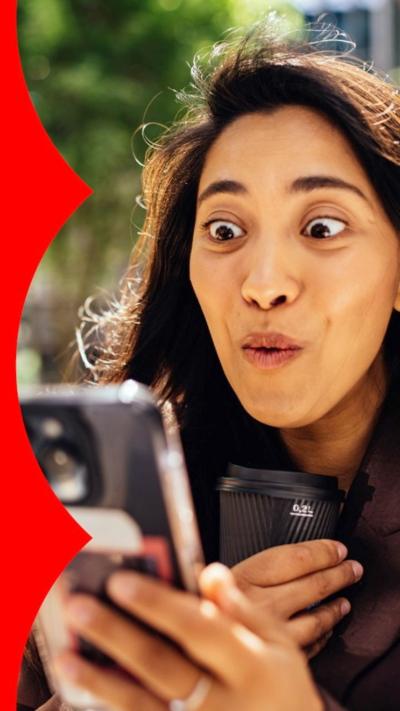 A woman smiling at her phone
