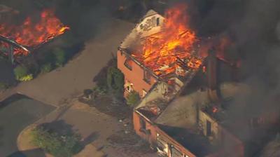Aerial footage Flames and a plume of black smoke engulfing houses on residential street in Stourbridge  
