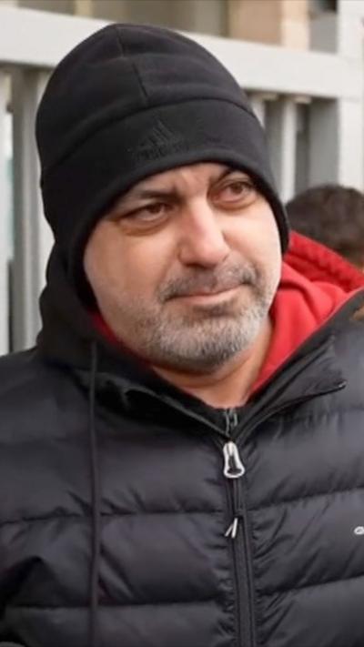 Man in black beanie hat and black puffer jacket