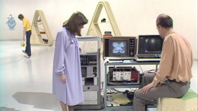 Tina Heath stands beside John Mitchell, and a machine that can create video effects