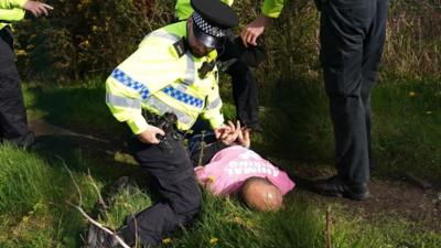 Police arresting Grand National protester