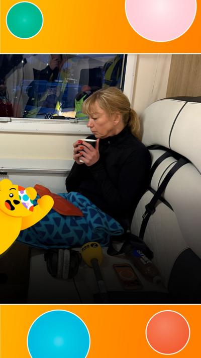 Sara looks tired whilst holding a disposable cup.