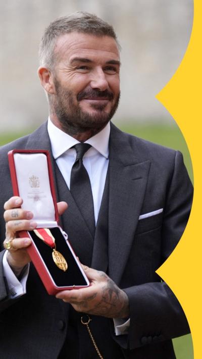 Sir David Beckham poses after receiving his knighthood