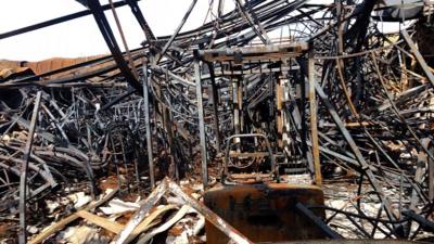 Footage from inside one of 40 destroyed buildings shows debris, mangled metal and a collapsed roof.