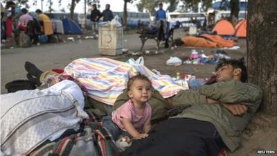 A migrant familly sleeps in a park near the main bus and train station in Belgrade