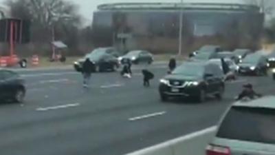 People grabbing cash on highway