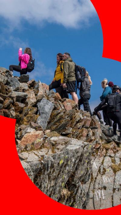 Queues of people waiting to reach the summit of Yr Wyddfa, also known as Mount Snowdon.