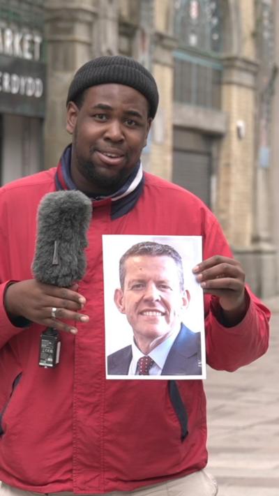 Terel Edmunds holding a picture of Rhun ap Iorwerth