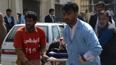 Pakistani volunteers rush an injured person for medical help following a bomb blast in Quetta, Pakistan