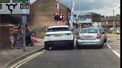 Driver jumps level crossing lights