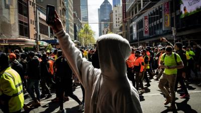 Man walks in Melbourne protest