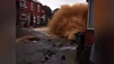 Burst pipe's water gushes high into the air