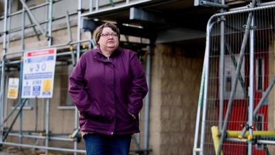 Margaret standing outside her flat