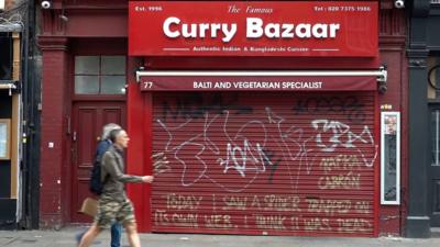 A curry restaurant with its shutter down