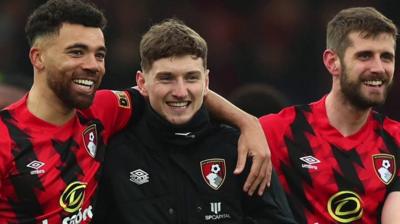 Ryan Fredericks (L) and Jack Stephens (R) join David Brooks in celebrating his return