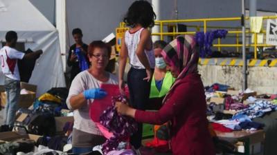 Migrants receive donated clothes