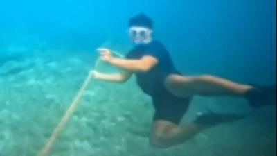 A diver cutting the barrier