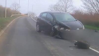 Damaged car after driver crashed into an oncoming vehicle.