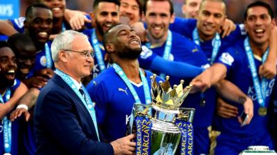 Leicester City captain Wes Morgan and manager Claudio Ranieri lifting the Premier League trophy together.