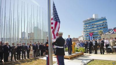 Secretary of State John Kerry, and other dignitaries, watch as US marines raise the US flag over the newly reopened embassy in Havana, Cuba