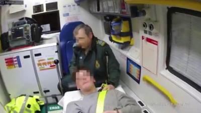 A paramedic and patient inside an ambulance