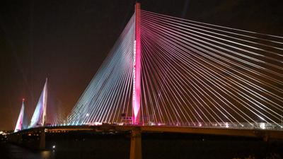 Bridge at night lit up with coloured lights